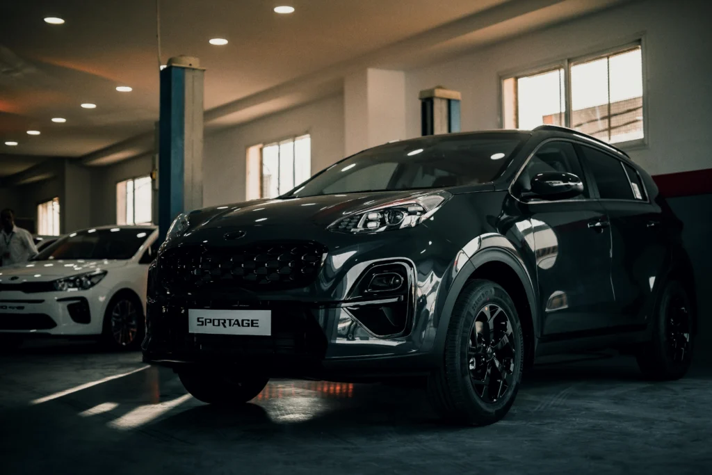 Dark grey premium SUV parked inside a modern well-lit car showroom representing top selling car brands in India.
